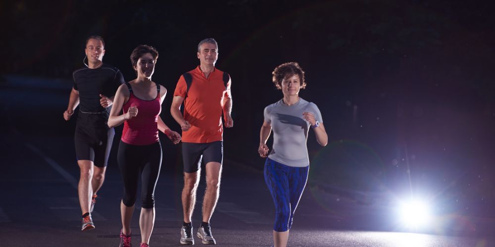 four people running at night
